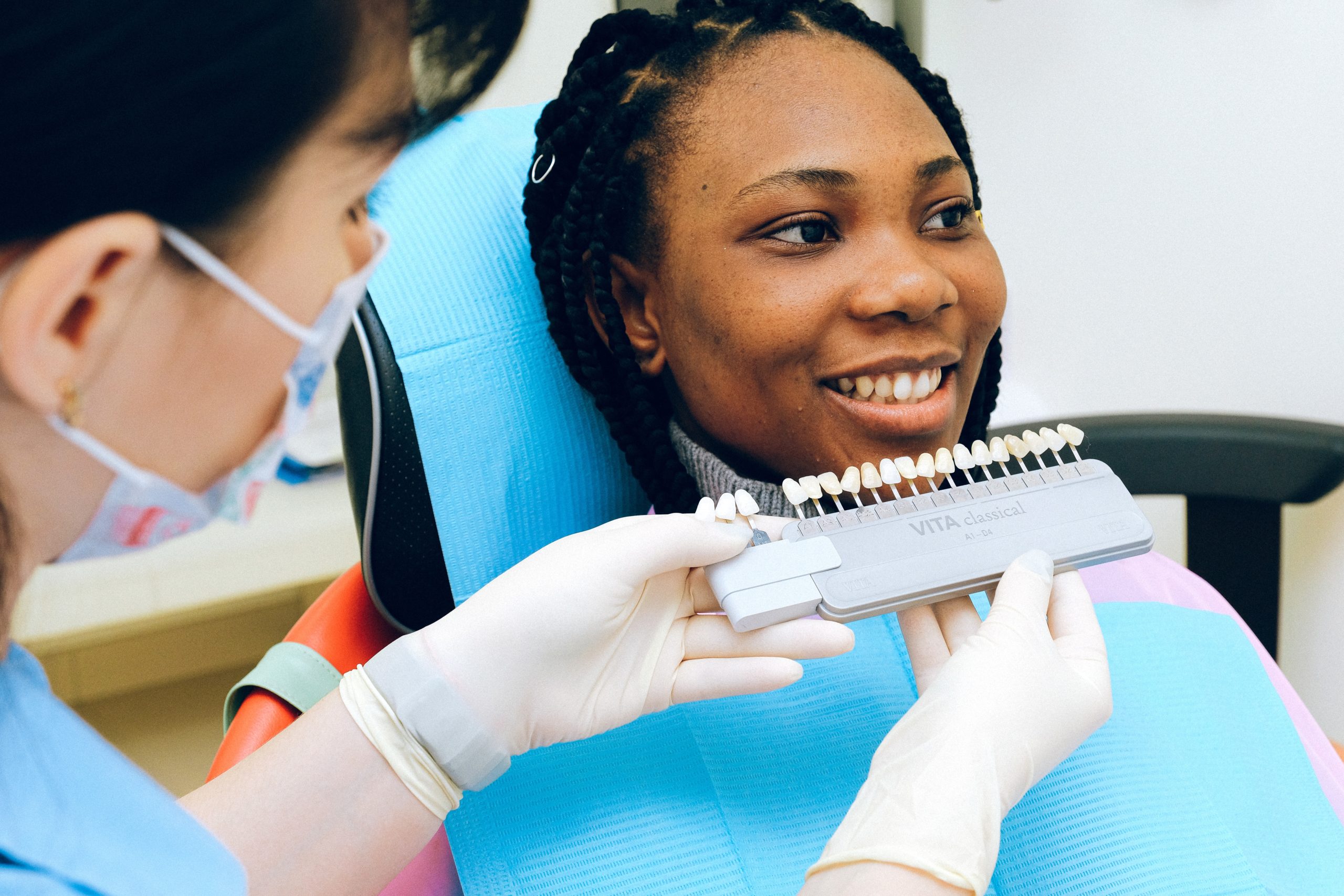 Female patient and dentist looking at dental implant options