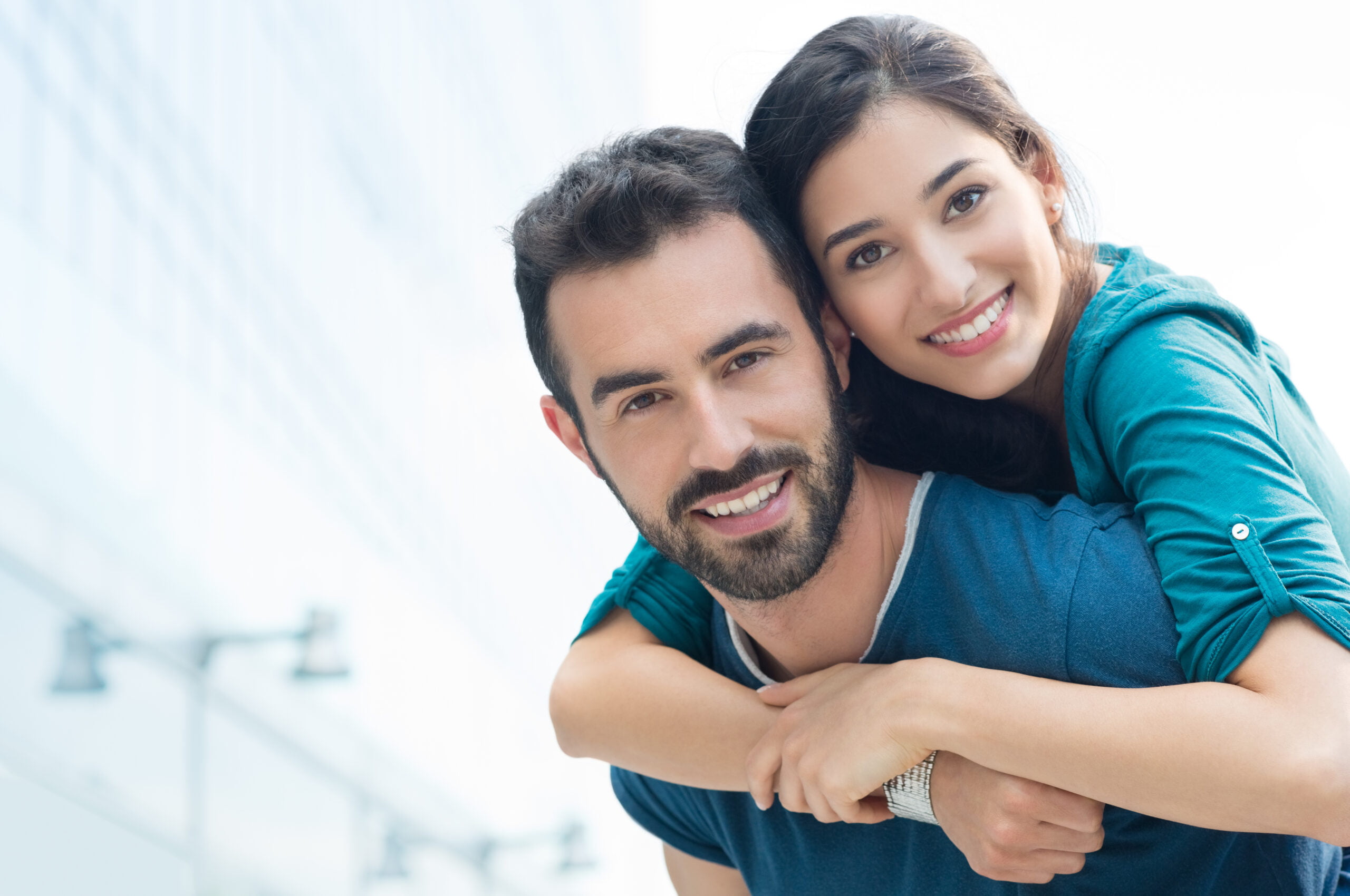 Happy young couple smiling at the camera