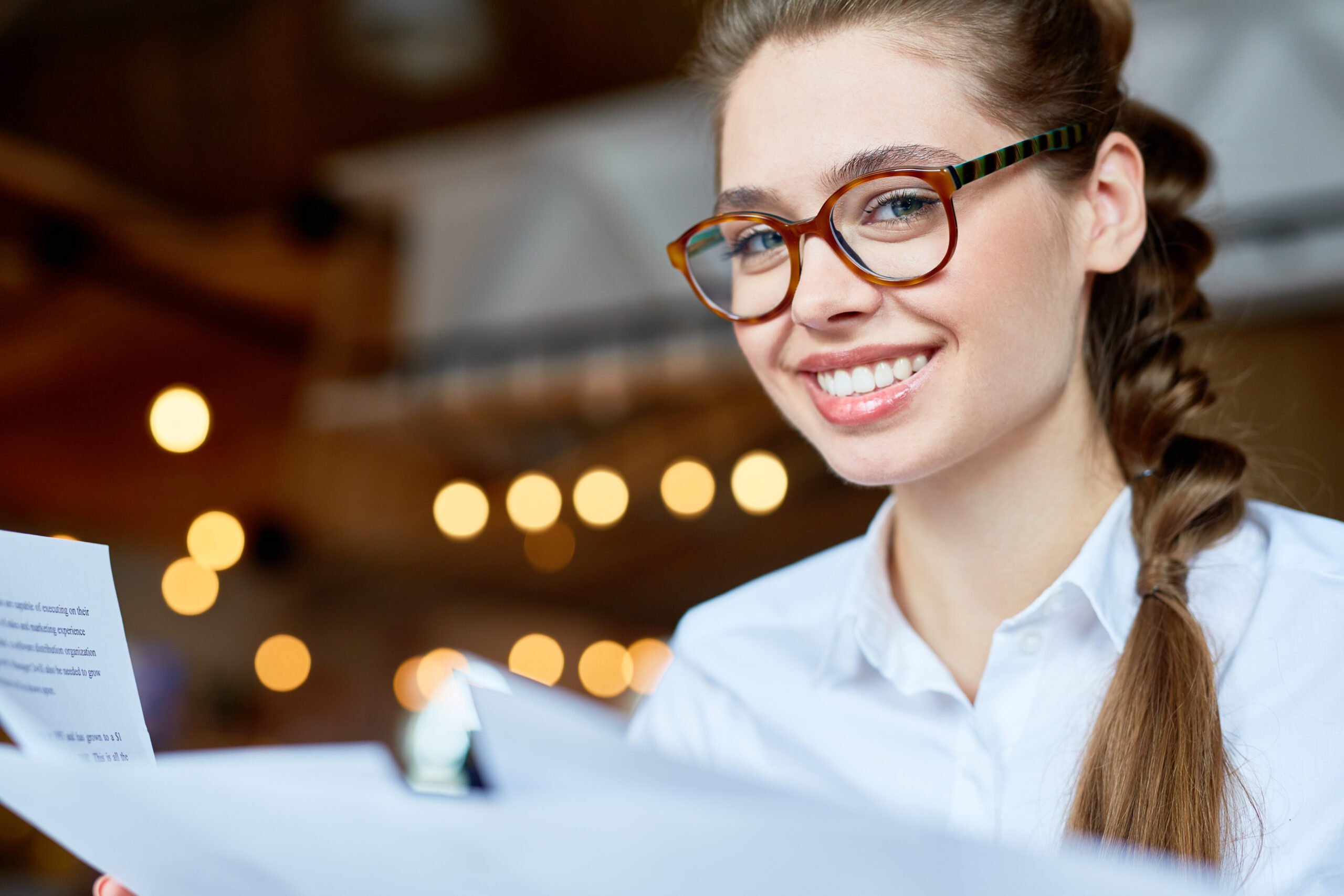 Woman in glasses smiling at the camera